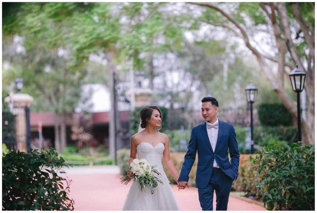 Timeless wedding photo of the bride and groom walking hand in hand at Curzon Hall.